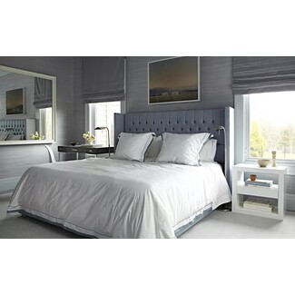 Stylish bedroom with bold wallpaper and modern furniture