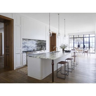 Traditional home kitchen with white cabinetry, black-and-white marble finishes, and antique/vintage-inspired pieces