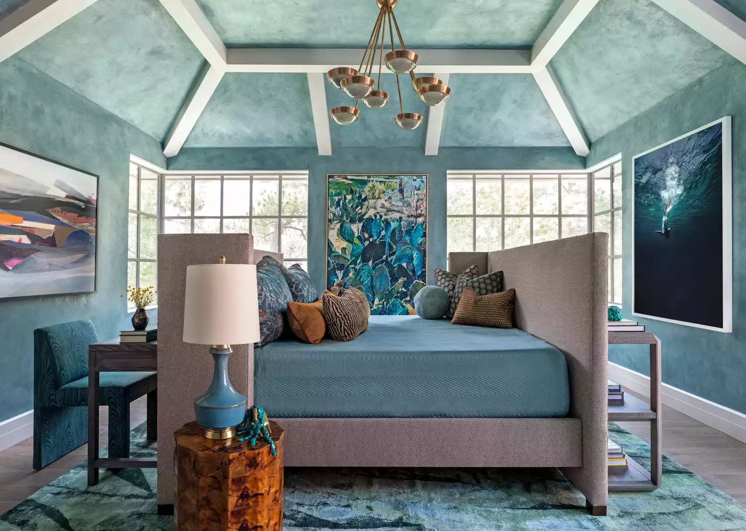 Serene bedroom with sky-blue painted beams and wallpaper
