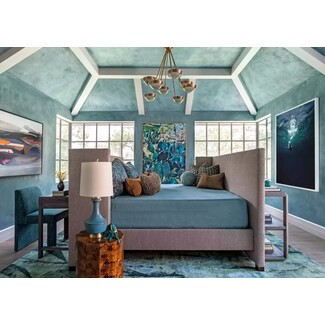 Serene bedroom with sky-blue painted beams and wallpaper