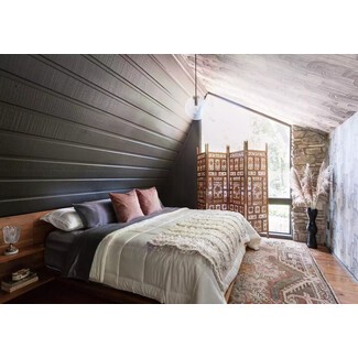 Vibrant bedroom with bold wallpaper and colorful accents