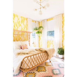 Vintage-style bedroom with antique furniture and floral wallpaper