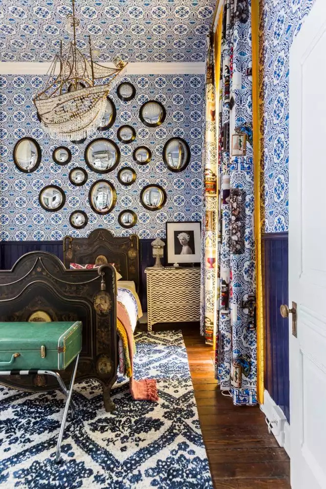 Cozy bedroom with wallpaper extended to the ceiling