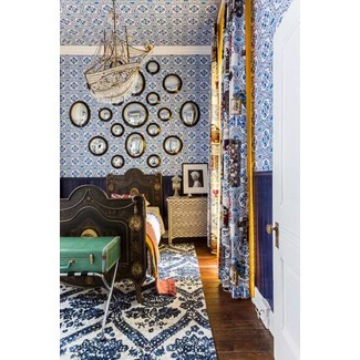 Cozy bedroom with wallpaper extended to the ceiling