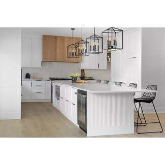 Mostly white and wood kitchen with airy black accents and warm flame bulbs