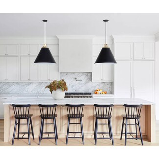 White and pale wood kitchen with Scandi-style black bar stools and pendant lights