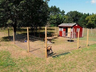 Animal Shelter Barn Red Siding with White Crossbuck Trim Barn