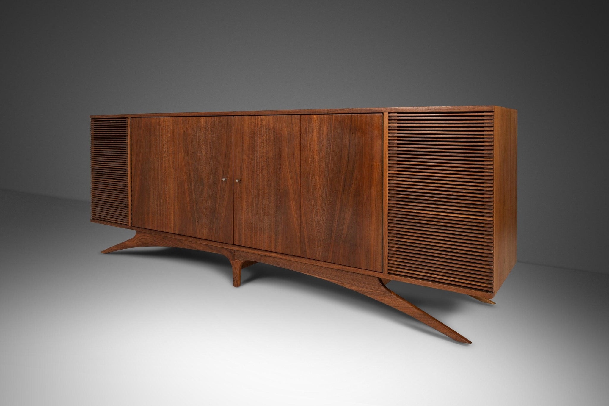 Credenza featuring Sculptural Base and Arched Legs