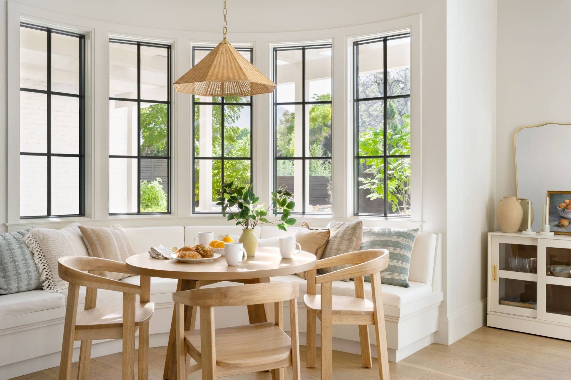 Curved Banquette with Woven Pendant and Black Frames