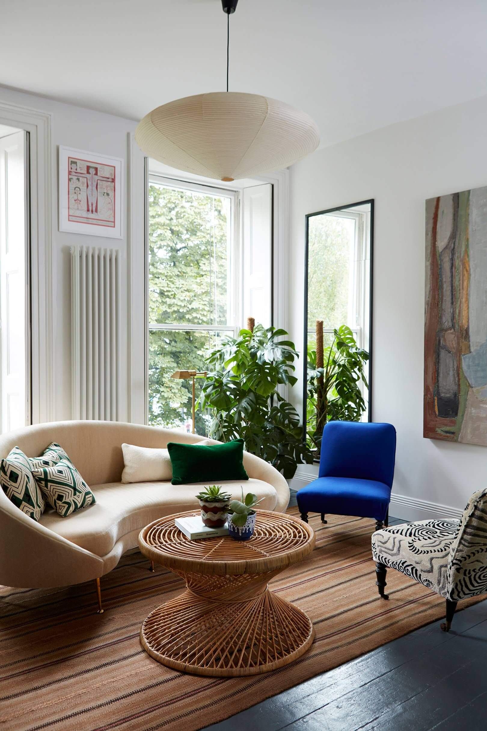 Curved Sofa featuring Hourglass Rattan Table in Eclectic Room