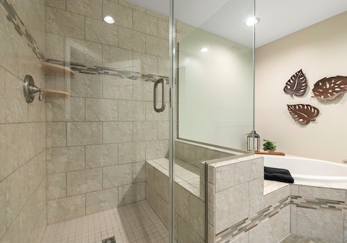 Glass Enclosure with Integrated Bench and Mosaic Tile Inlay