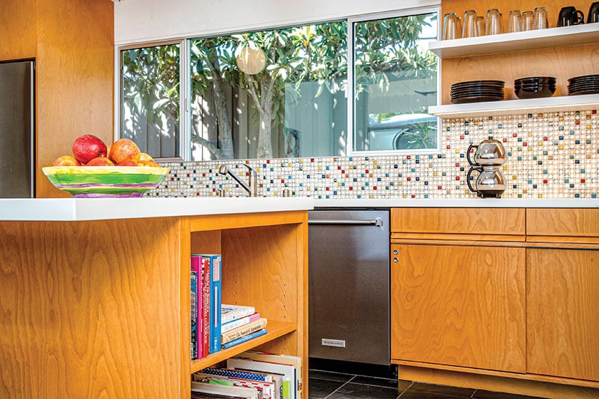 Kitchen Cabinetry with Multi Colored Mosaic Backsplash