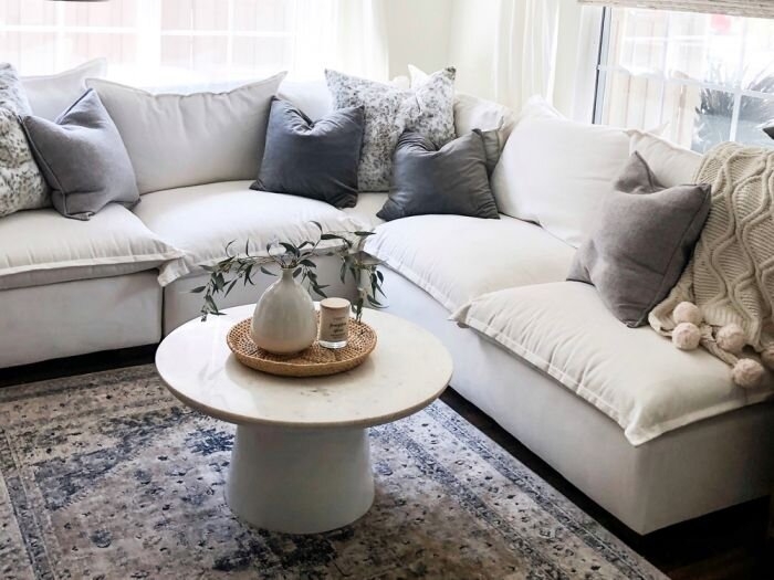 Modular Sectional with Plush Cushions and Pedestal Stone Table
