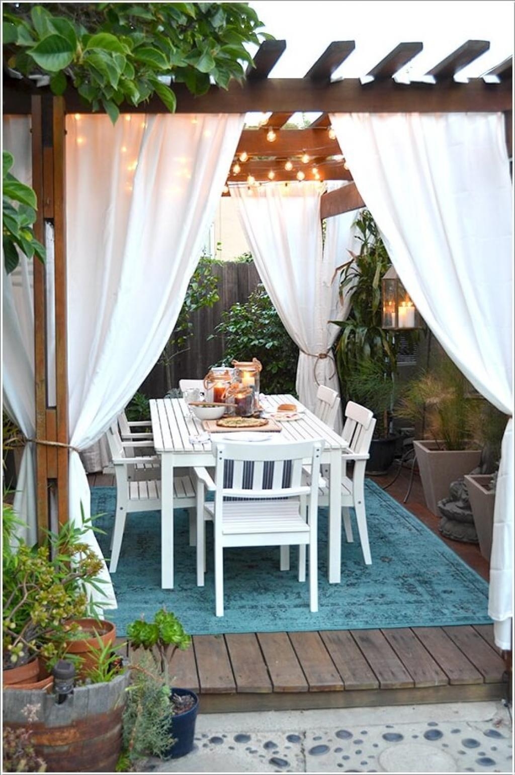 Outdoor Dining Set: Teal Patterned Rug and Bistro Lights
