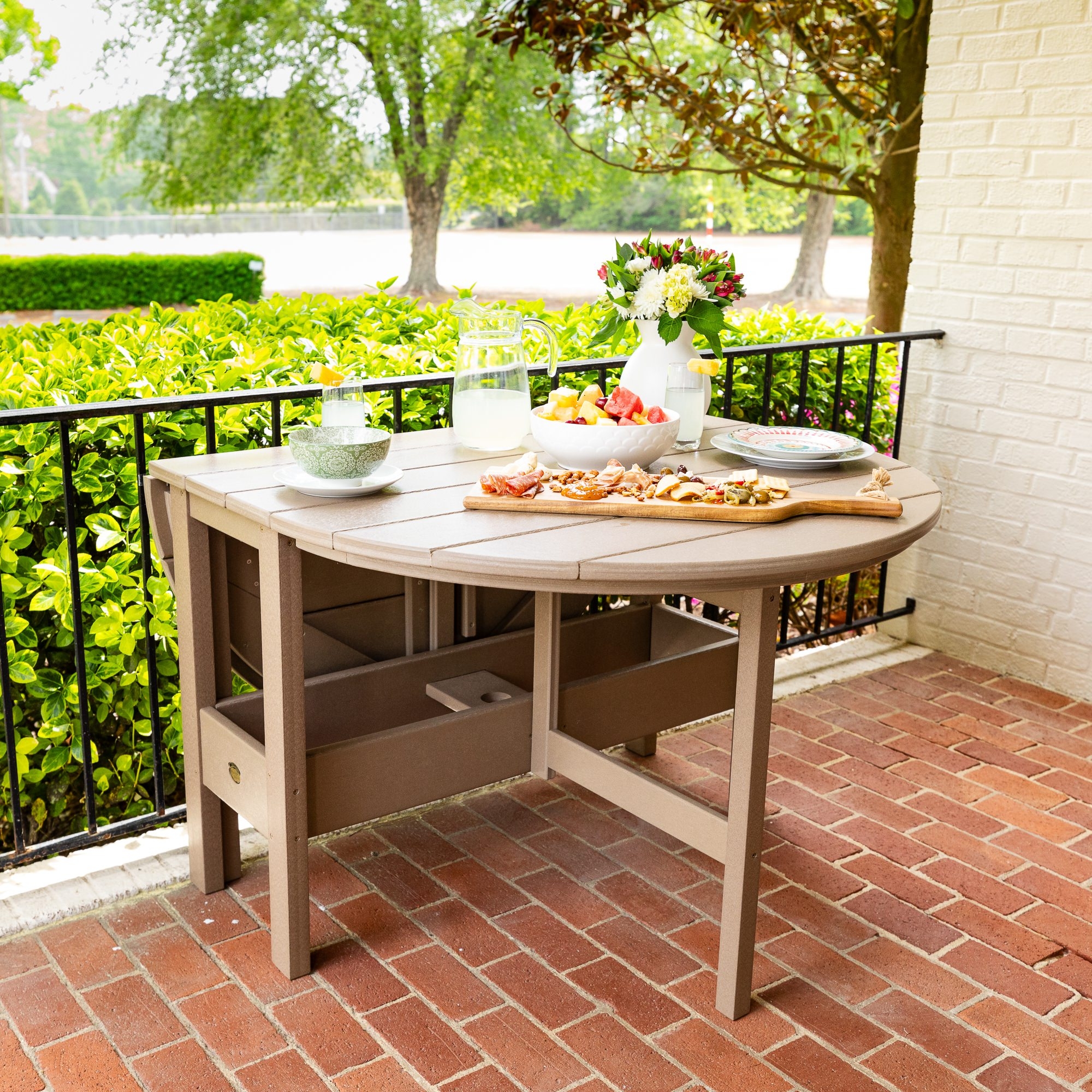 Outdoor Storage Dining Table with Taupe Wood Toned Poly Slats