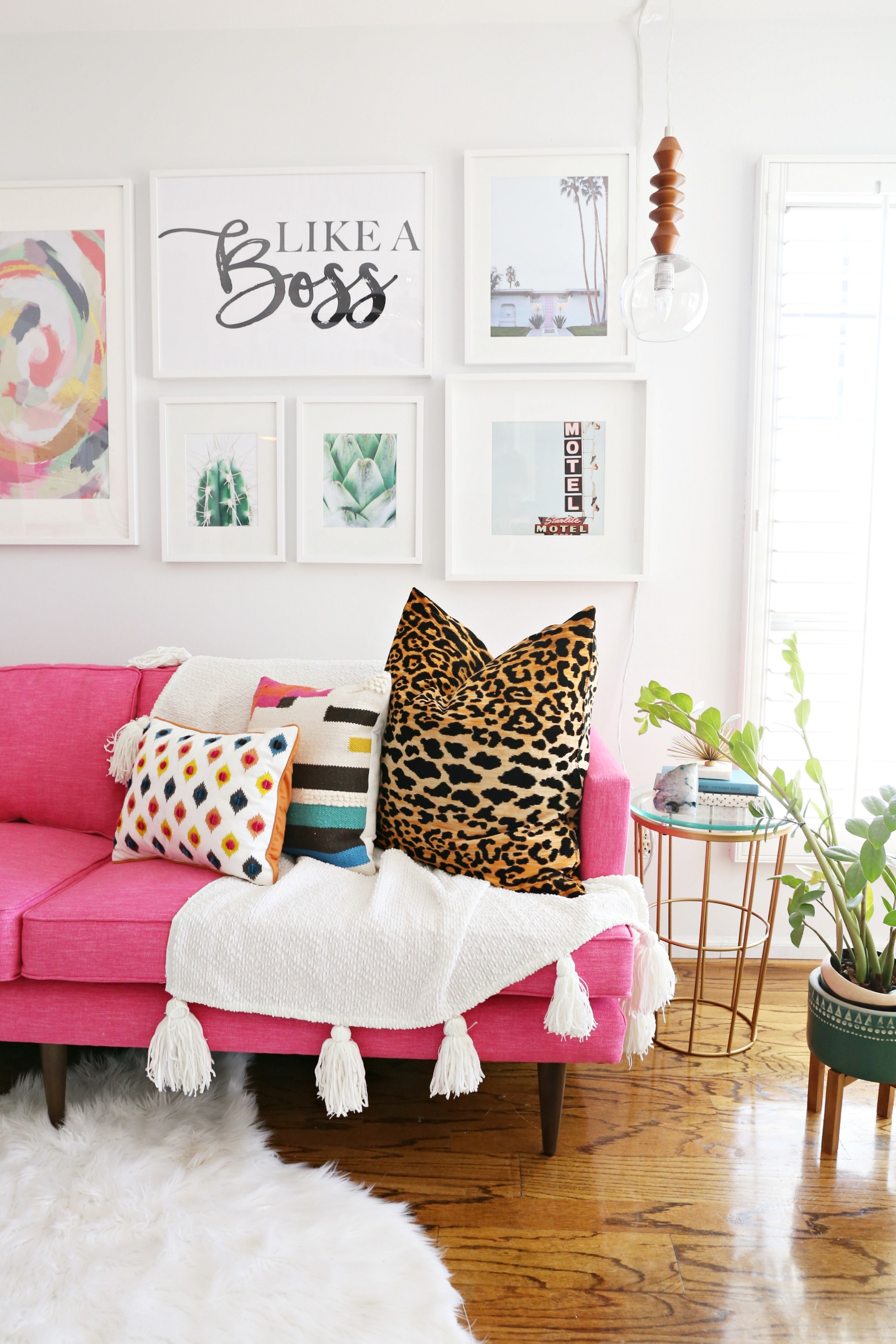 Pink Sofa with Leopard Print Pillow and Tasseled Throw