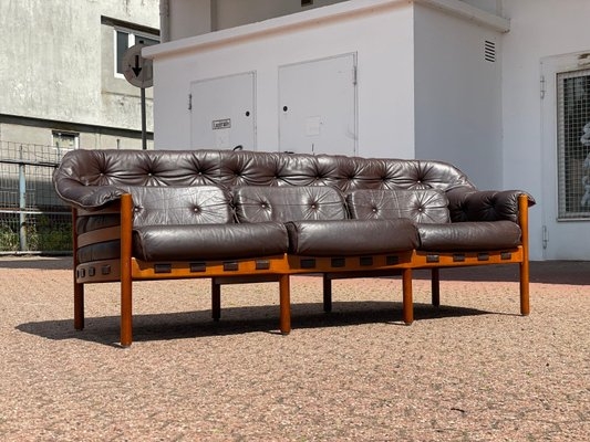 Sofa Featuring Patinated Leather and Six-Leg Wood Base