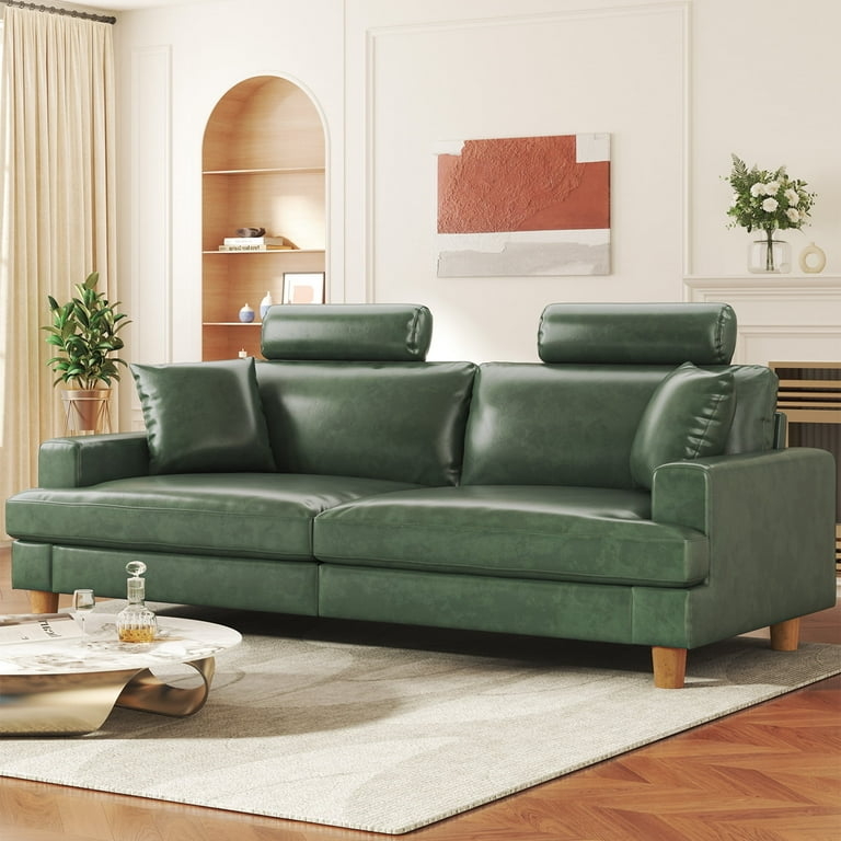 Sofa with cylindrical headrests in deep forest green