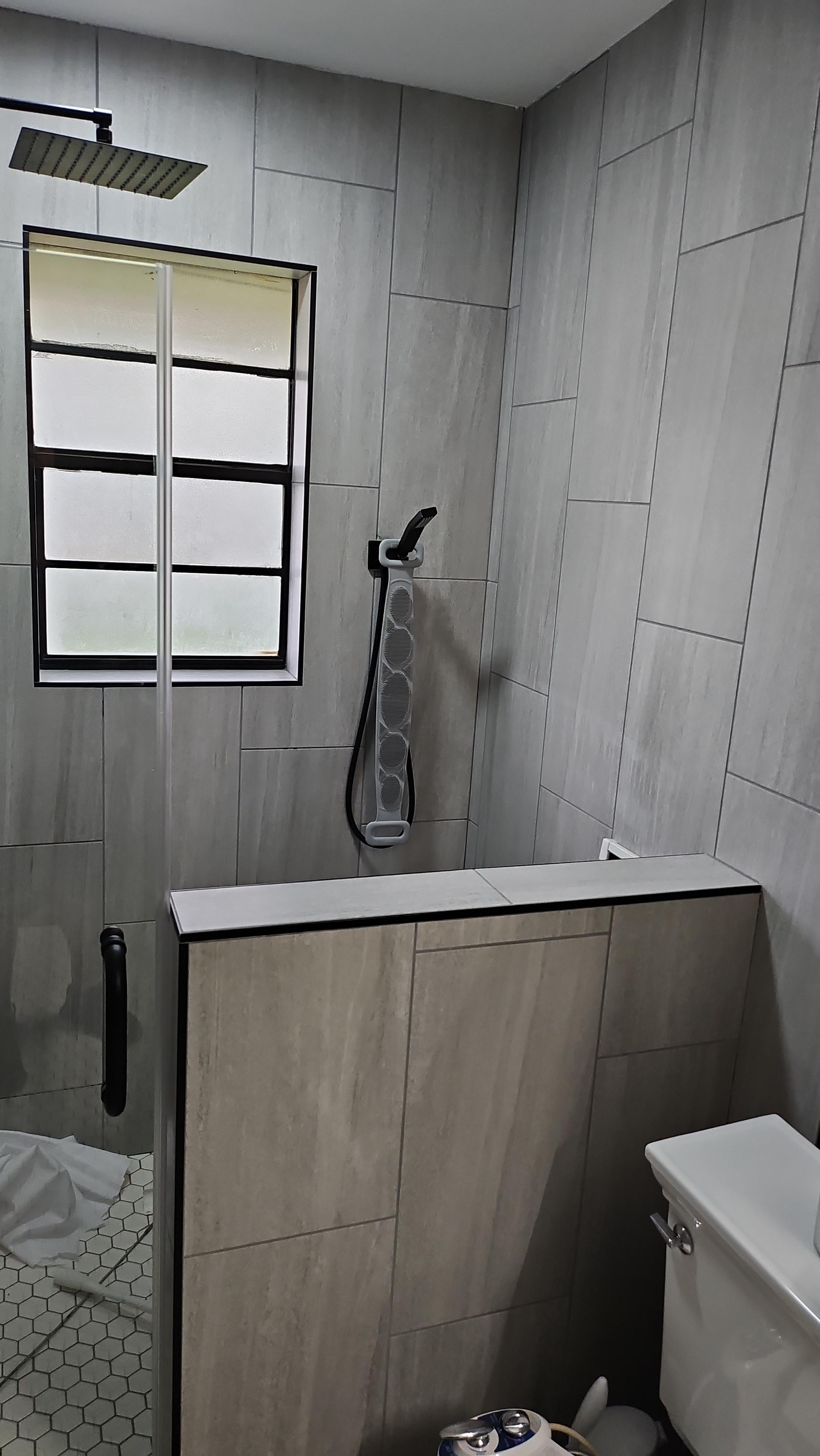 Walk-In Shower with Half Wall Partition and Black Grid Window