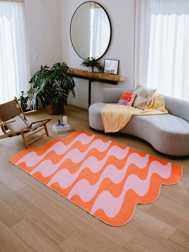 Wavy Scalloped Area Rug with Pink and Orange Pastel Gradient.