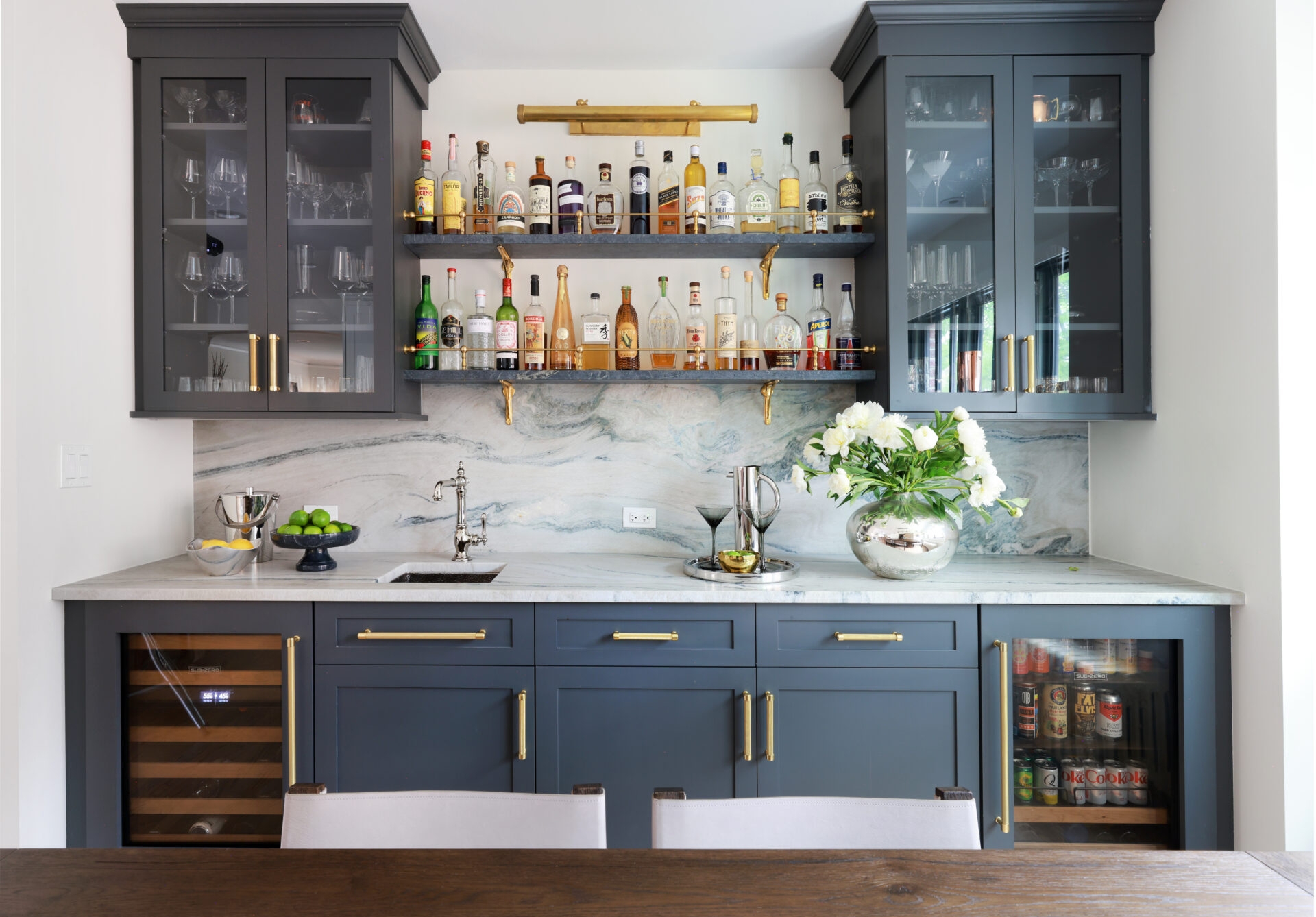 Wet Bar featuring Gold Gallery Light and Veined Marble Backsplash