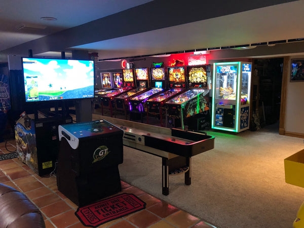 Arcade Game Room with Neon Glow and Pinball Row for Basement Ideas