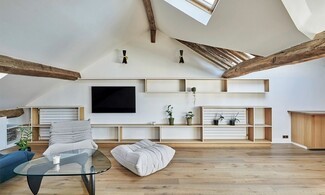 Attic Living Room: modern vaulted ceiling lighting and shelving