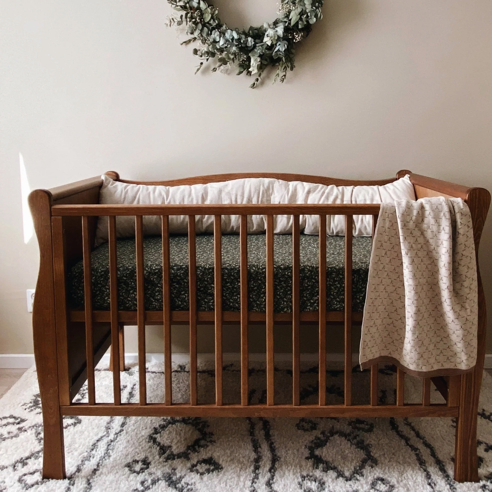 Baby Crib Sleigh Back Design with Walnut Brown Spindle Sides