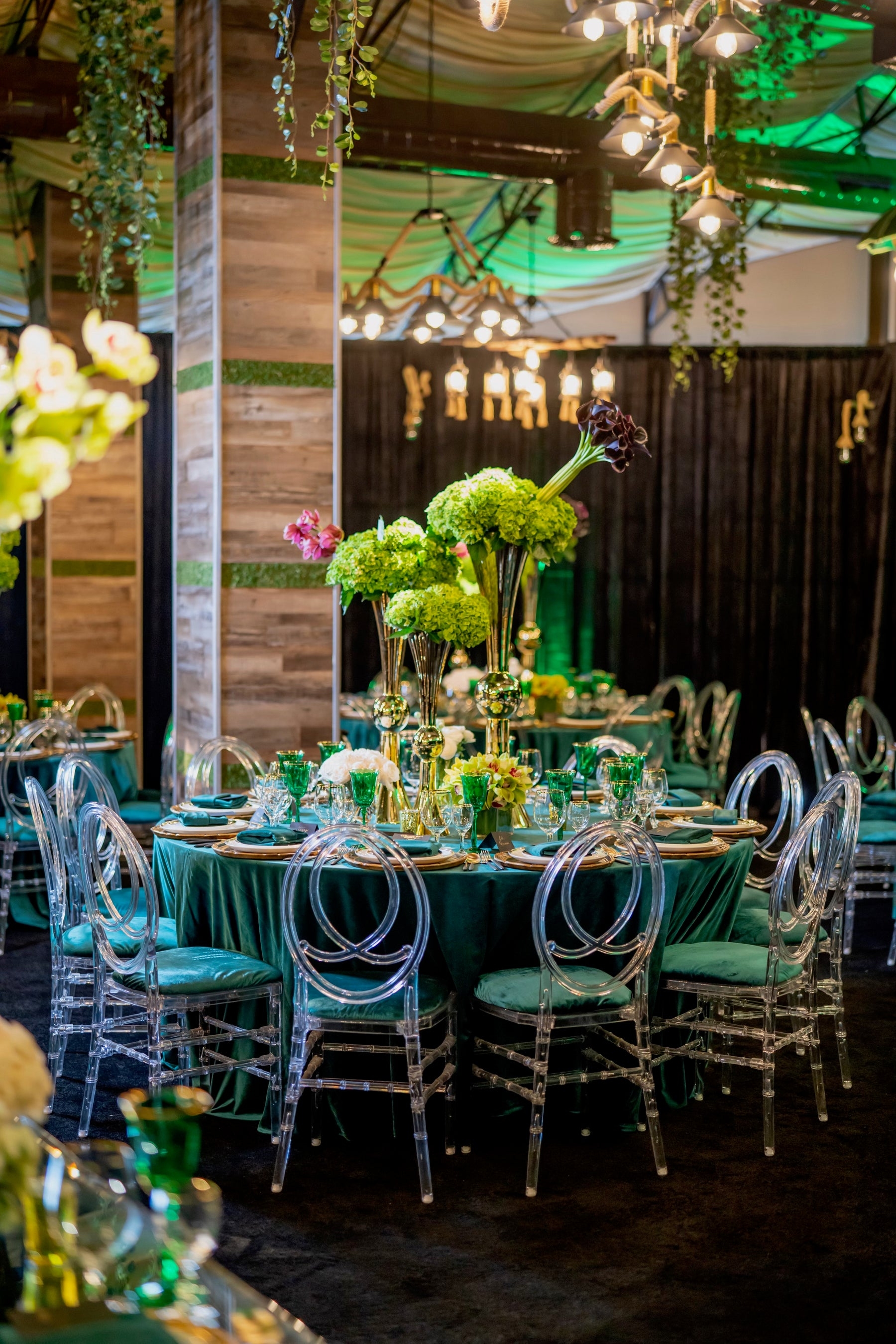 Banquet Table with Emerald Velvet Linens and Clear Chairs