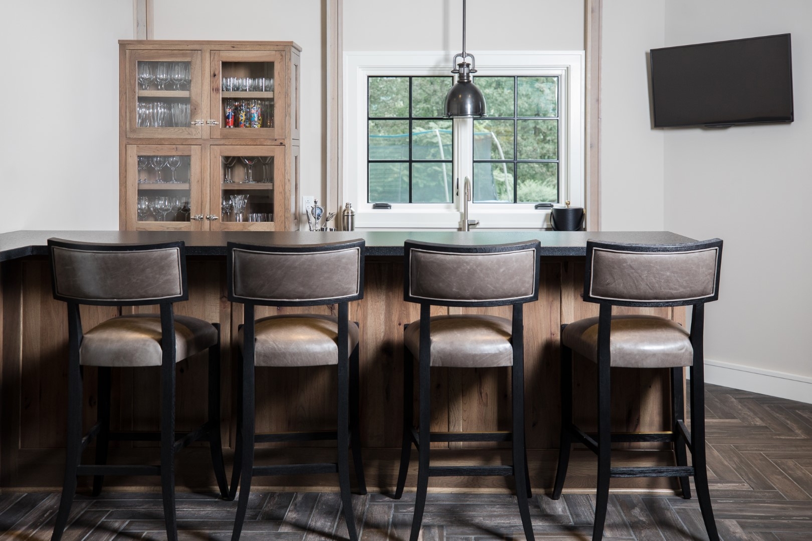 Bar Stool with Taupe Upholstery and Herringbone Wood Flooring