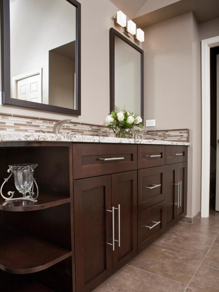 Bathroom Vanity: Dark espresso open curved shelving and mosaic border