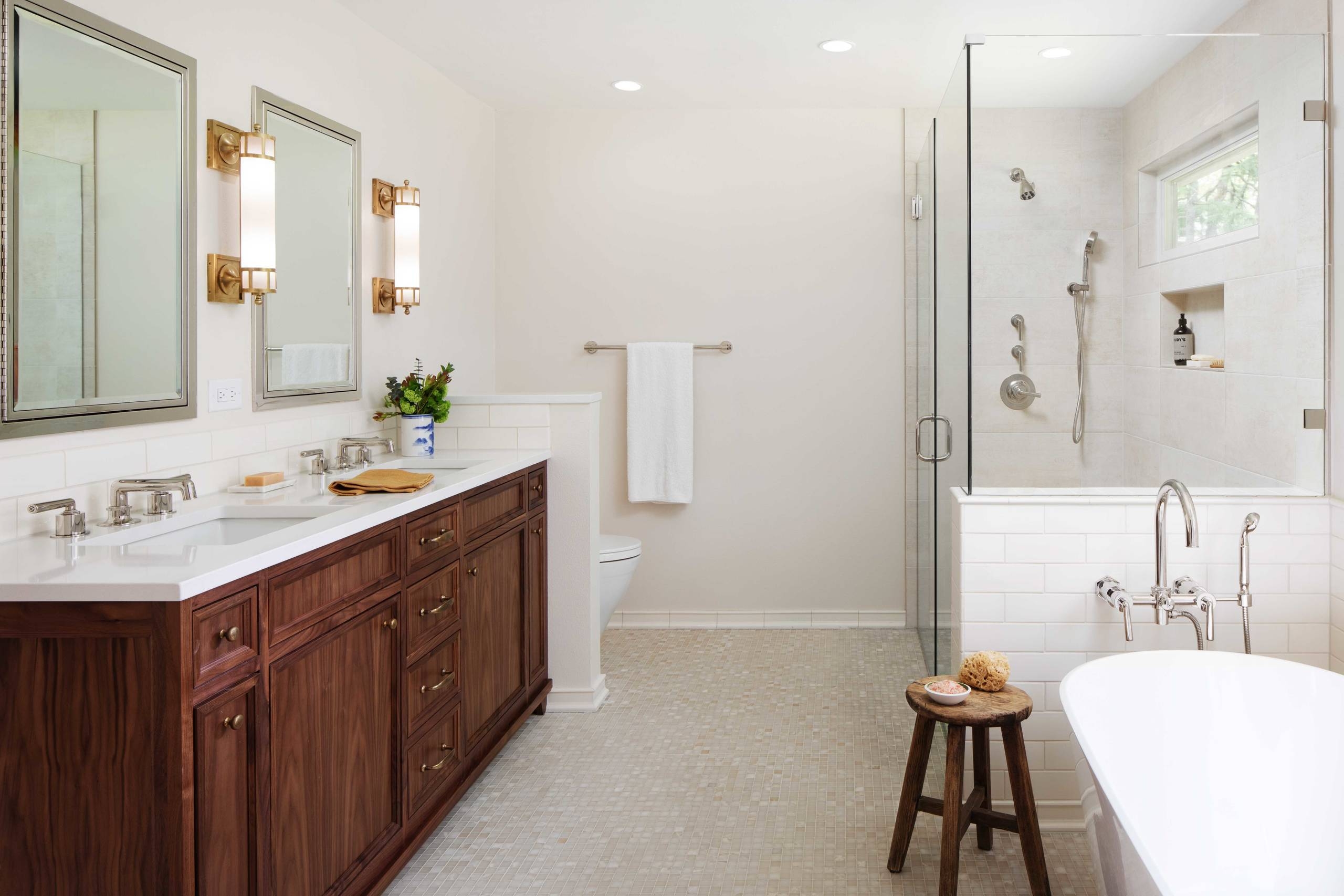 Bathroom Vanity: Dark wood cabinets with subway tile half wall