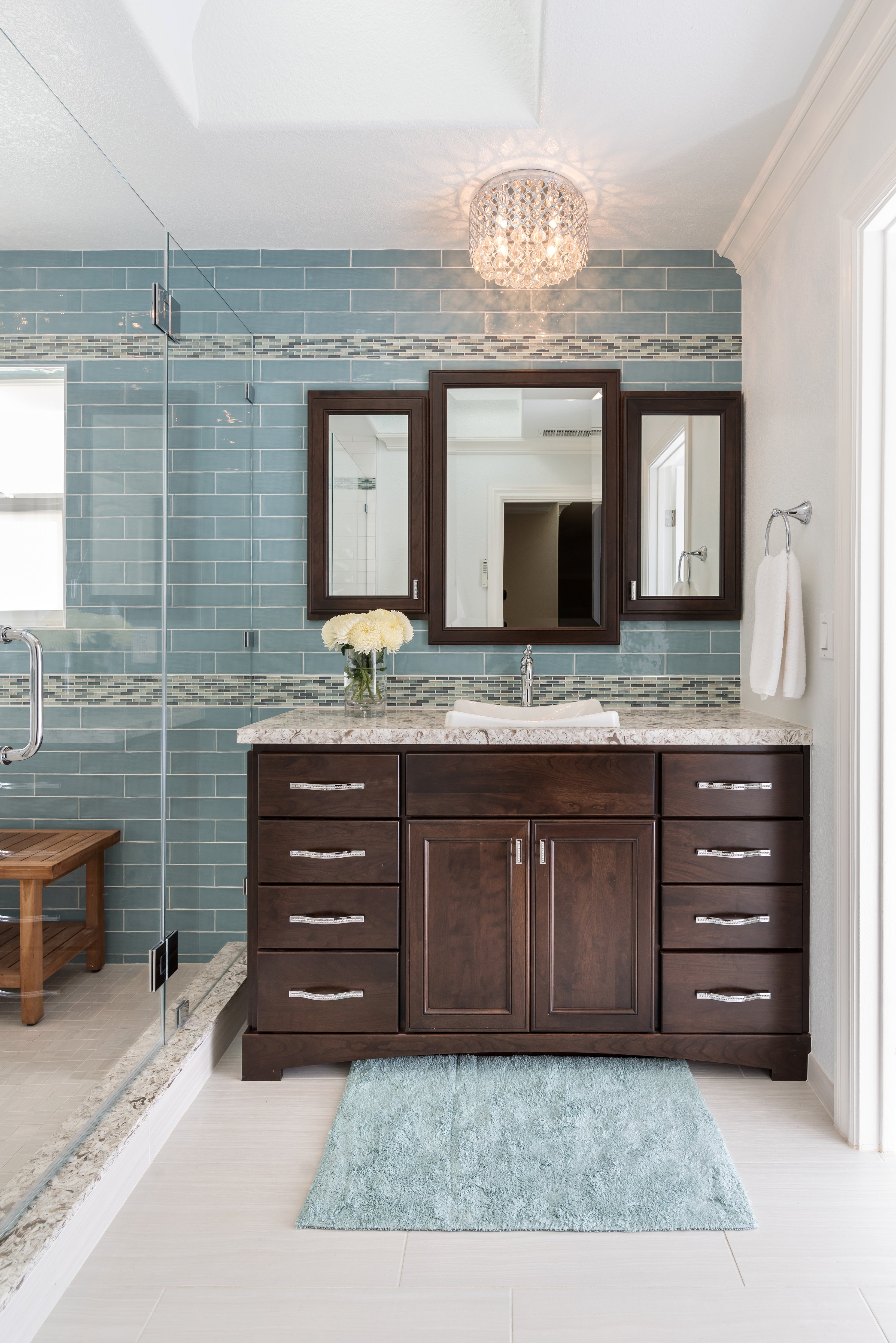 Bathroom Vanity: Tri-fold mirror espresso with blue subway tile wall
