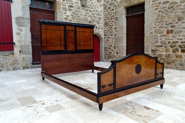 Bed Frame featuring Wood Paneling and Circular Medallion