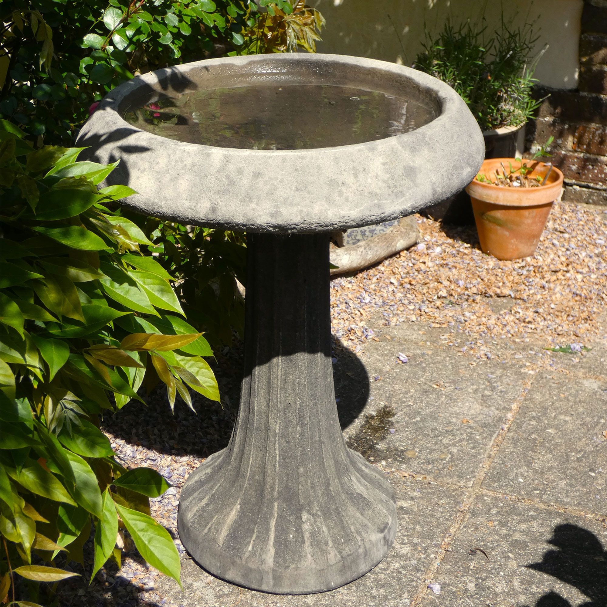 Birdbath Fluted Pedestal: Weathered Grey Stone-Like Feature