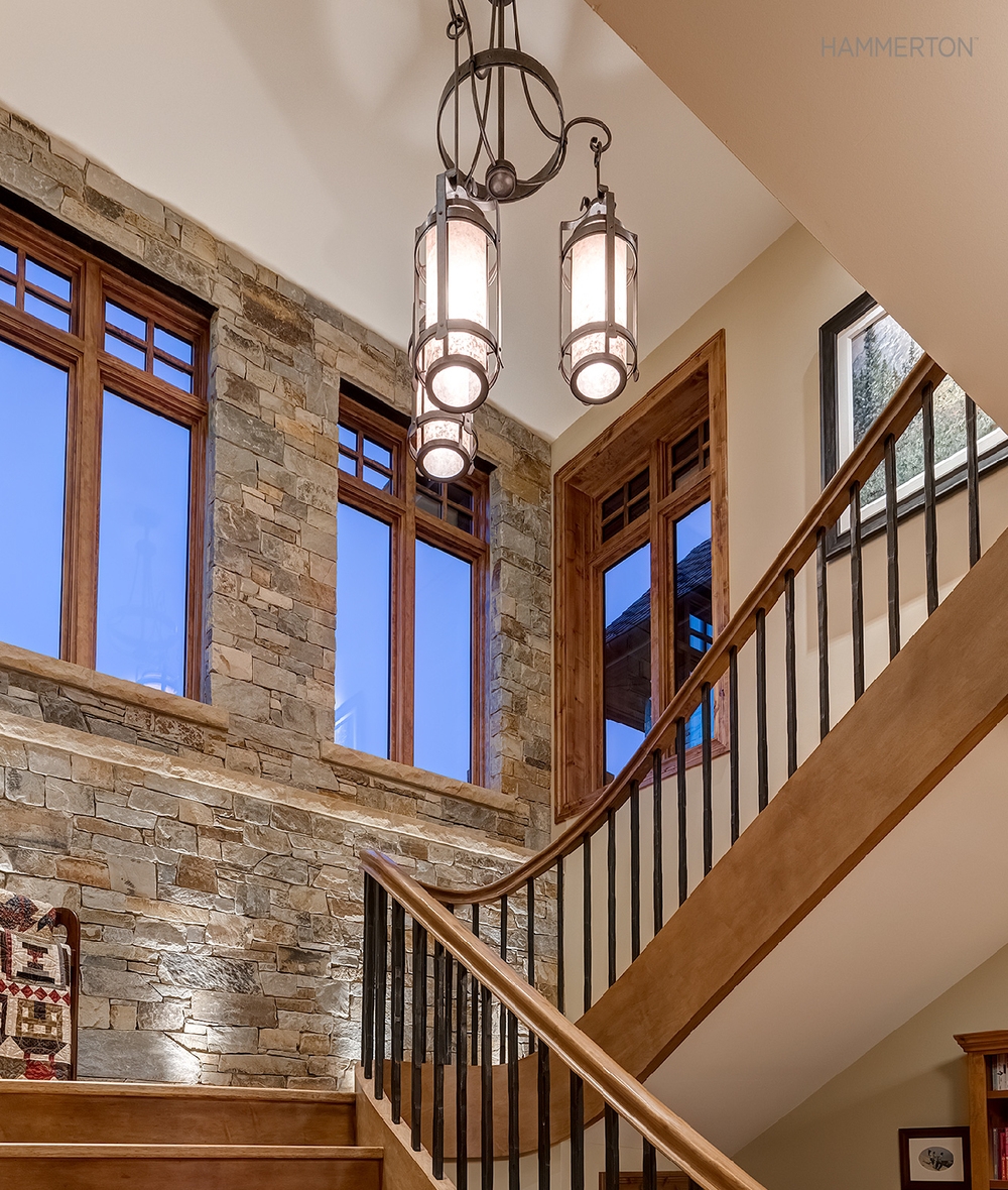 Chandelier with Cylindrical Pendants Over Stacked Stone