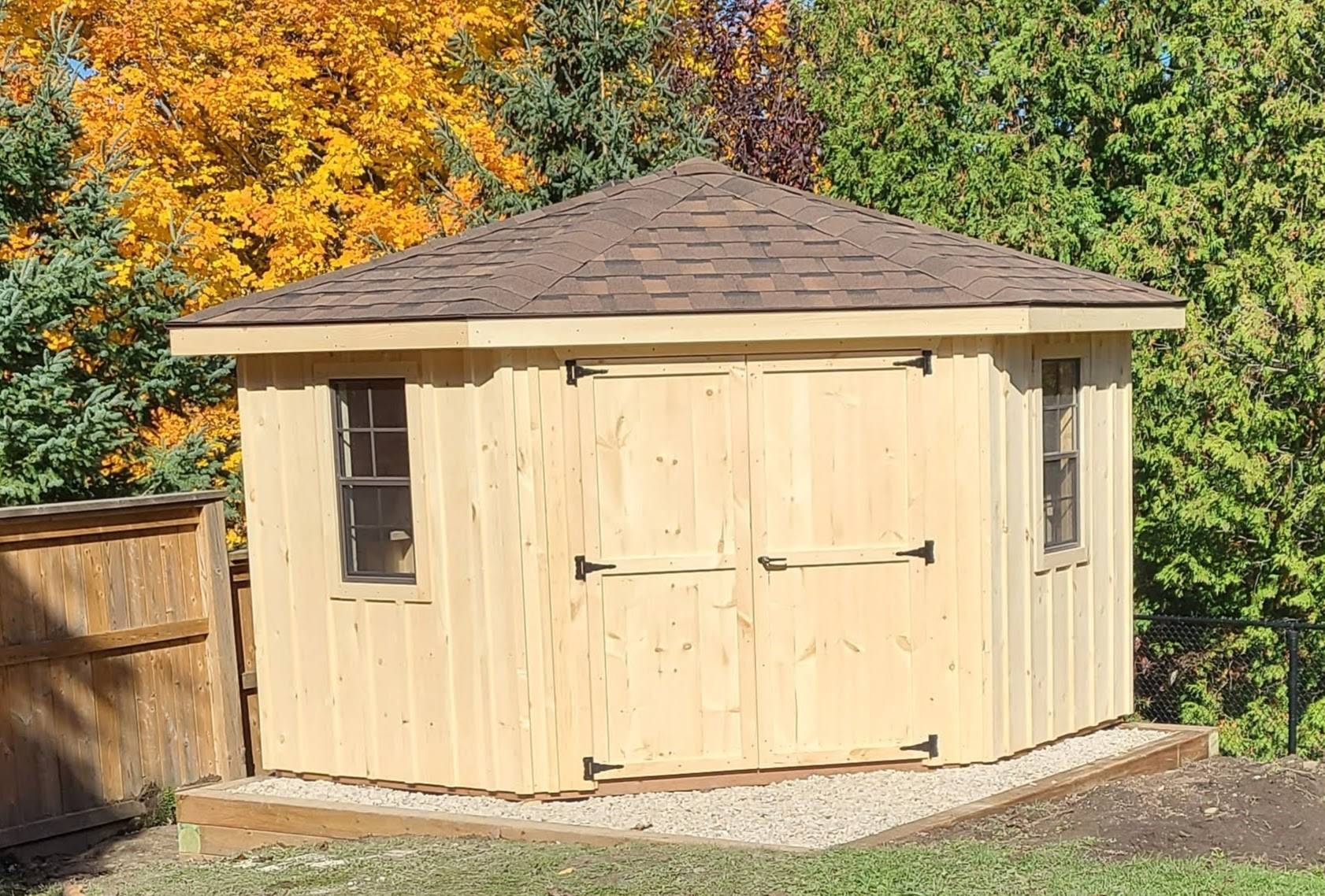 Corner Shed with natural pine siding and strap hinges