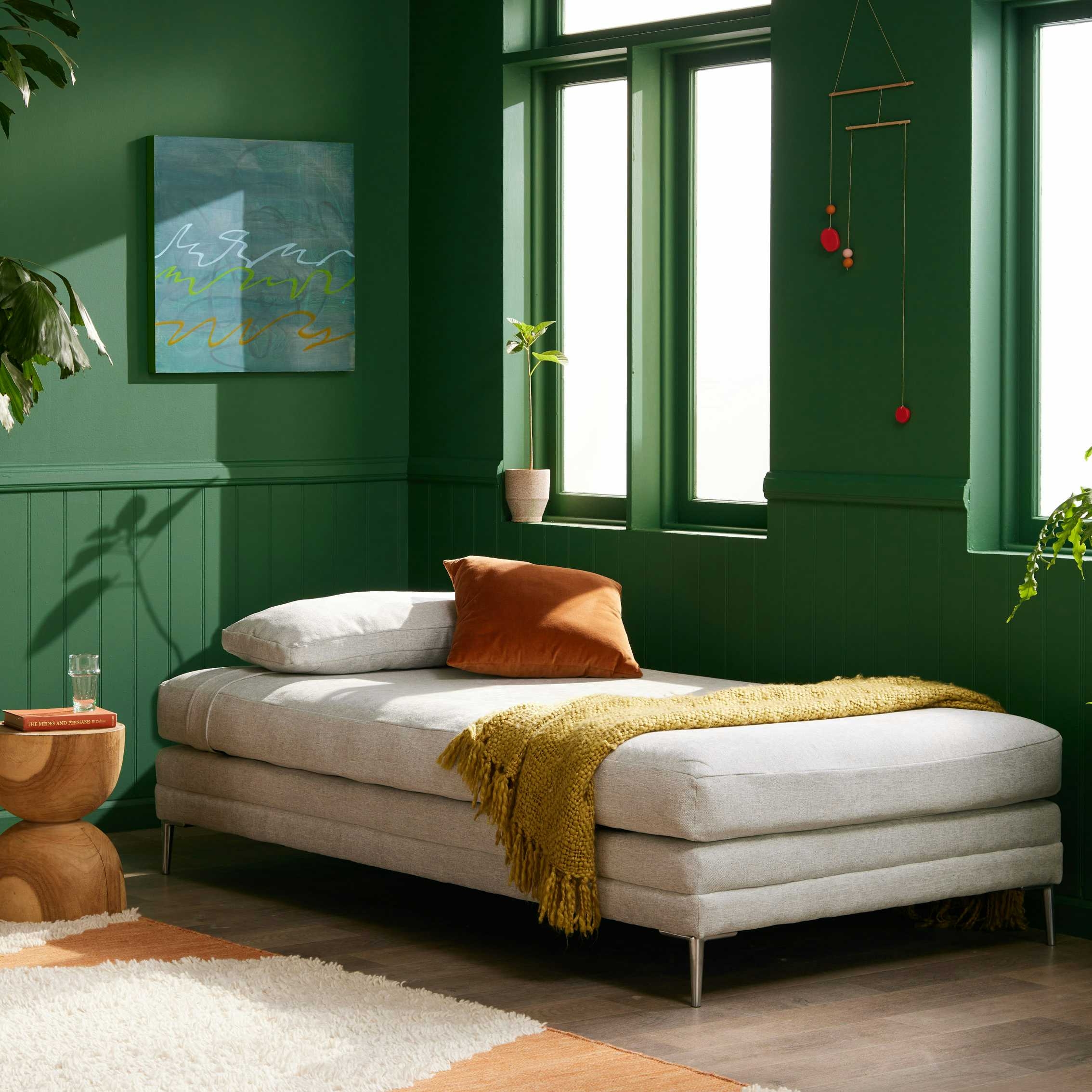 Daybed with Tapered Metal Legs in a Monochrome Green Room