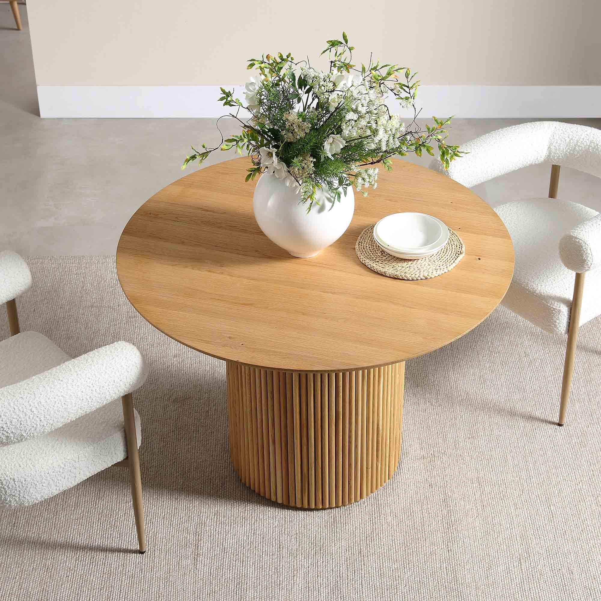 Dining Table: Light wood fluted pedestal and textured upholstery