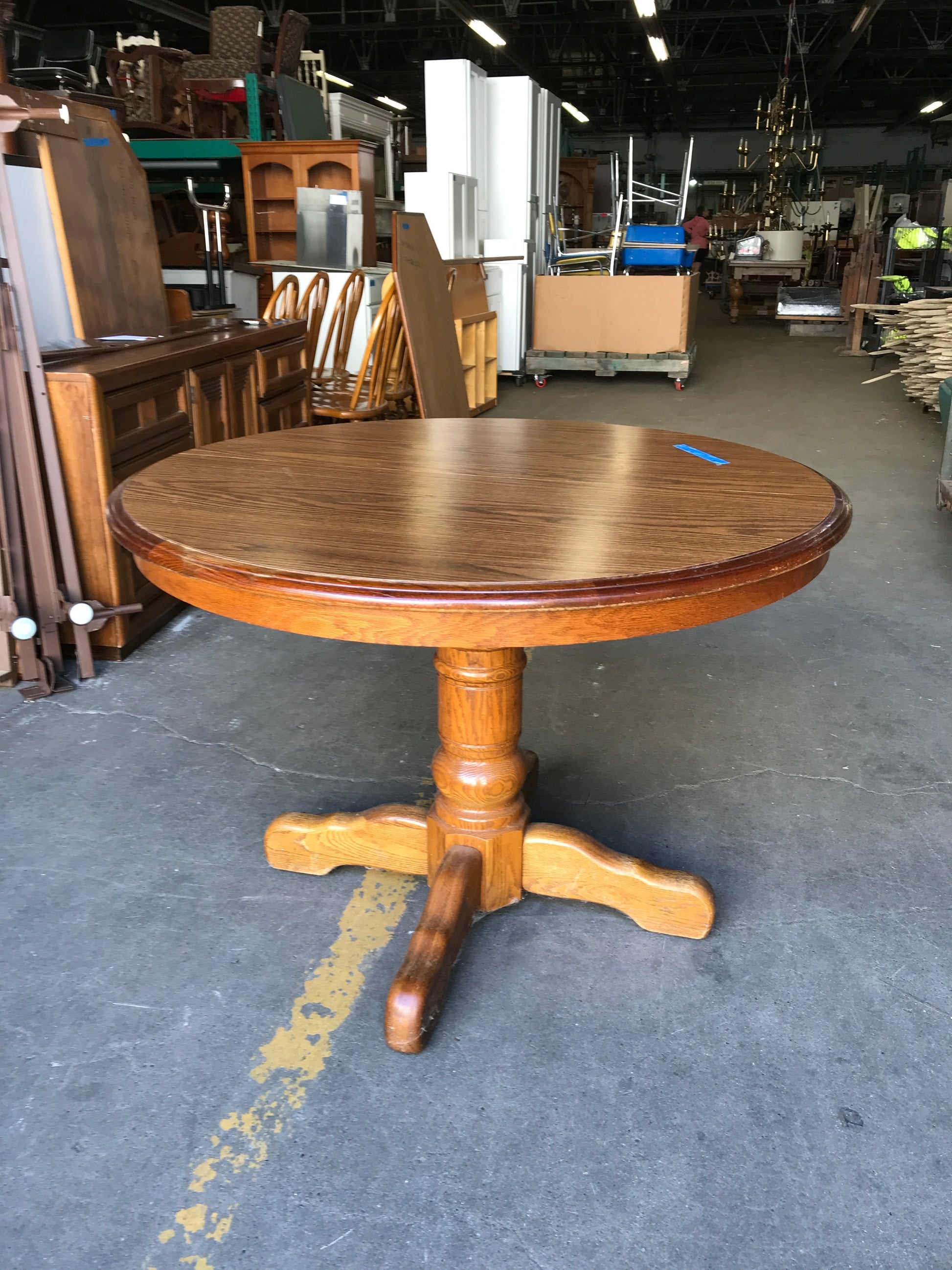 Dining Table: Turned column pedestal with dark edge trim