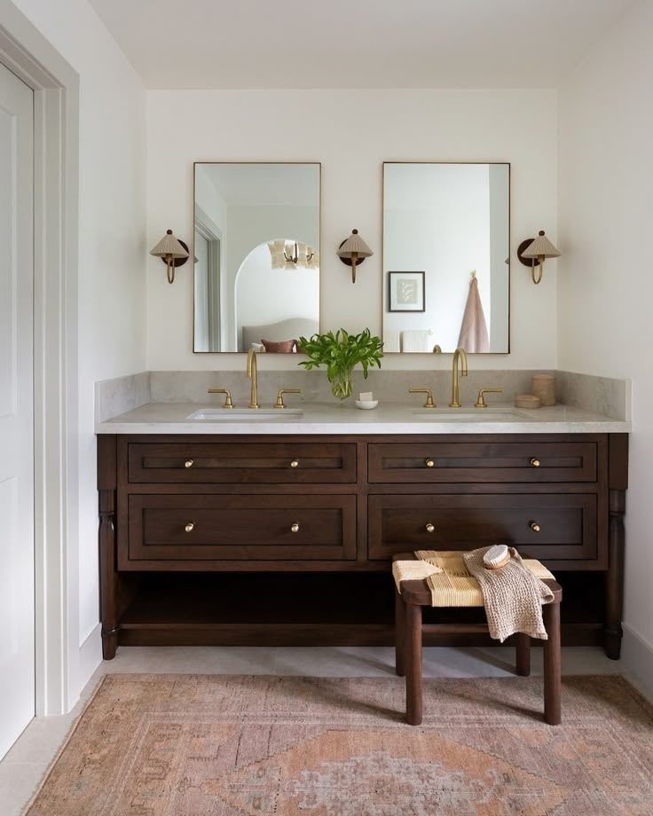 Double Vanity: Brown bathroom cabinet with pleated shade wall sconces