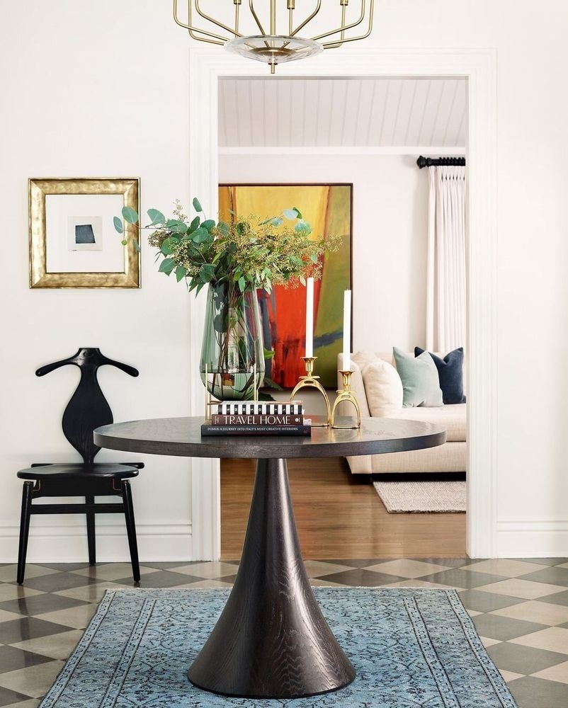 Foyer Table With Conical Pedestal And Sculptural Black Chair