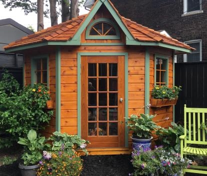 Garden Shed featuring fanlight window and sage green trim