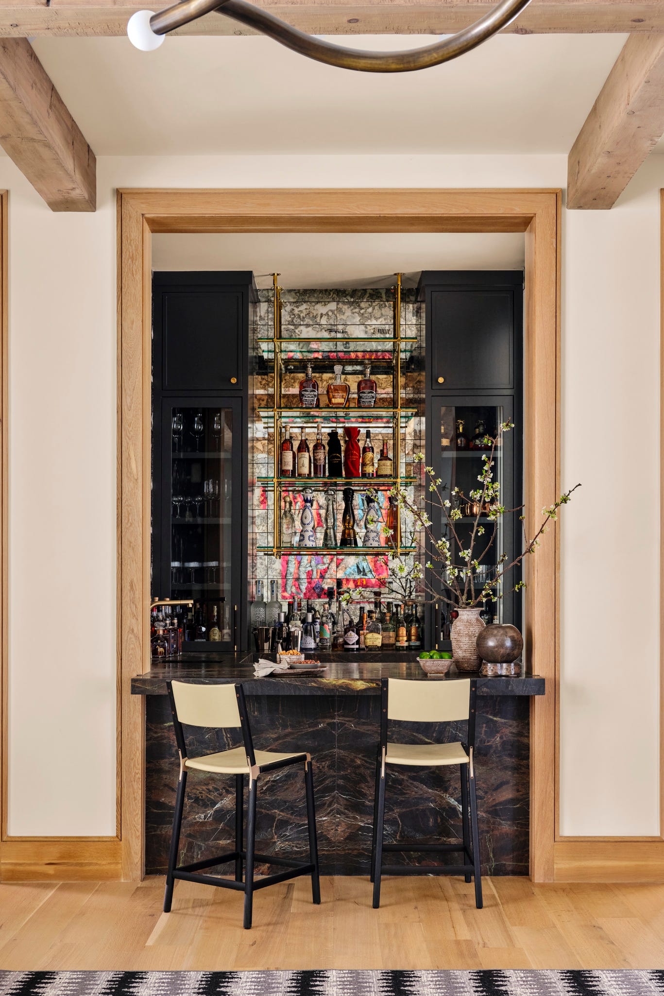 Home Bar with Book Matched Stone Base and Matte Black Cabinets