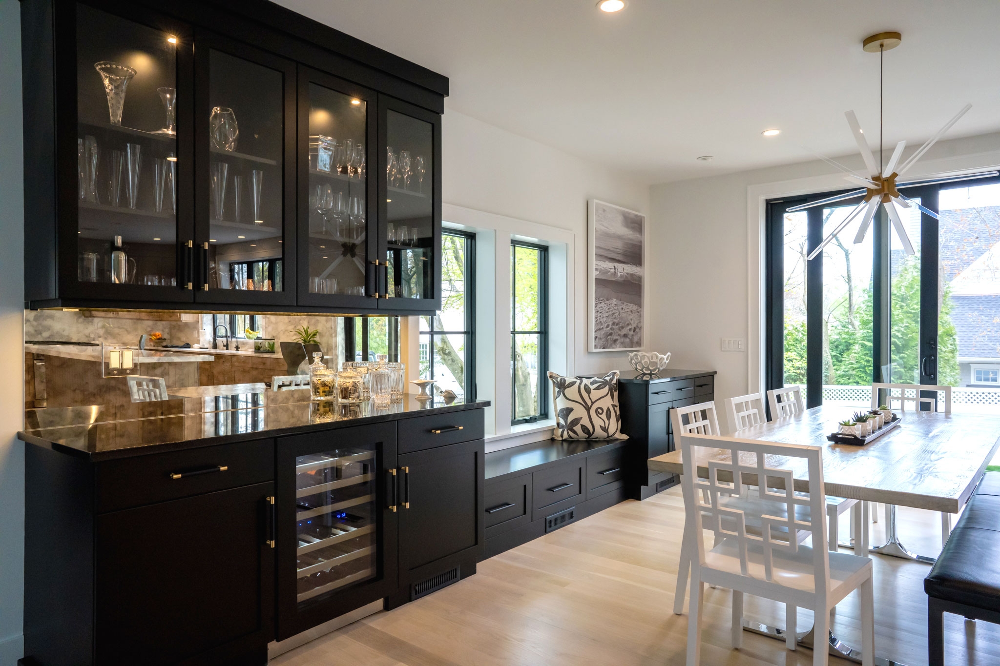 Home Bar with Geometric Fretwork Chairs and Mirrored Backsplash