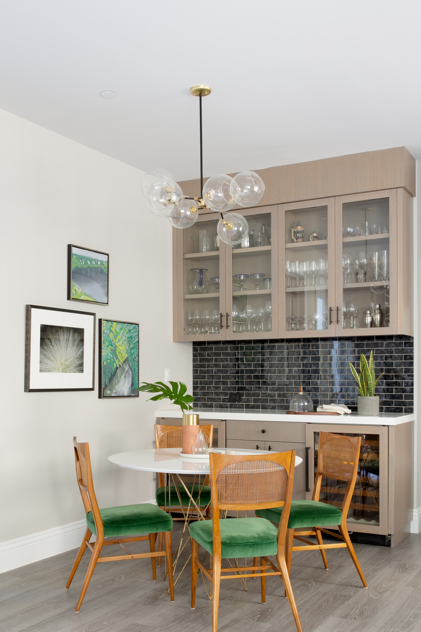 Home Bar with Green Velvet Seating and Cane Back Dining Chairs