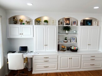 Home Office Cabinetry with Arched Niches and Brass Hardware
