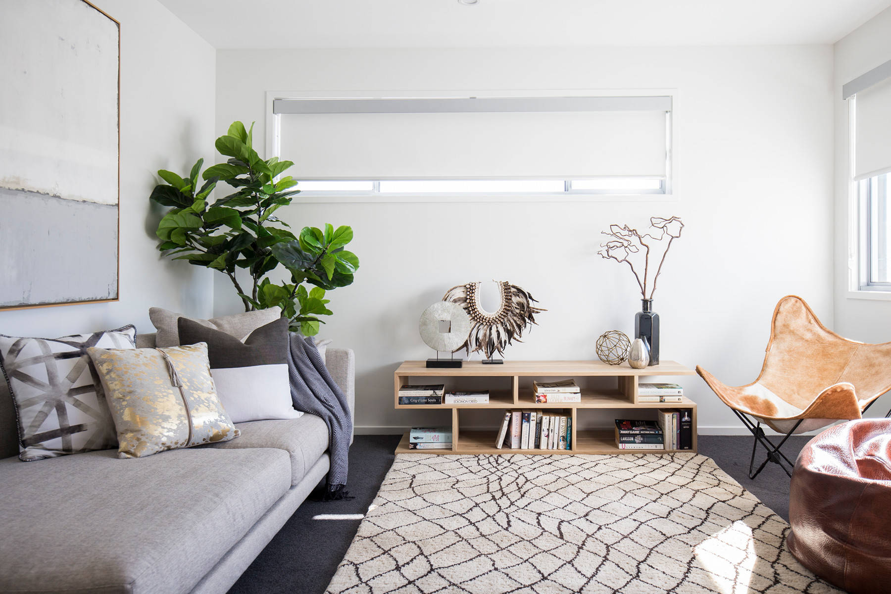 Living Room Interior with Charcoal Carpet Base and Layered Rugs