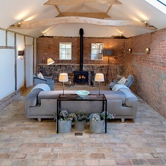 Living Room: rustic timber beam lighting with brick pavers
