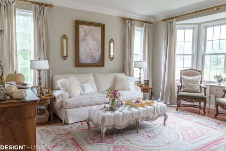 Living Room Set featuring Tufted Ottoman and Floral Area Rug Styling